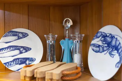 a table with two plates and two vases and cookies at Stargazy in St Ives