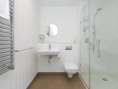 a bathroom with a toilet and a sink and a shower at Stargazy in St Ives