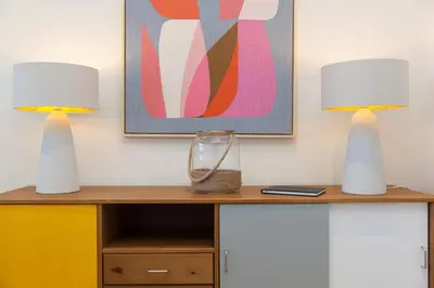 two lamps sitting on top of a dresser at Secret Beach in Carbis Bay