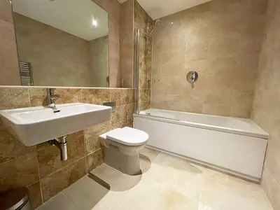 a bathroom with a sink and a toilet and a bath tub at 5 The Beach House in Saint Columb Minor