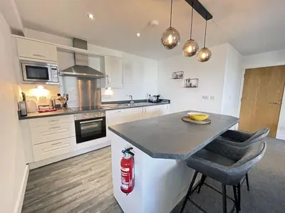 a kitchen with a counter and a fire extinguisher at 33 Ocean one in Newquay