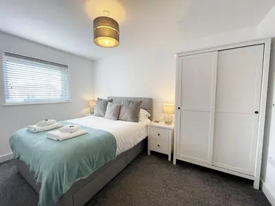 a bedroom with a large bed and a white closet at 33 Ocean one in Newquay