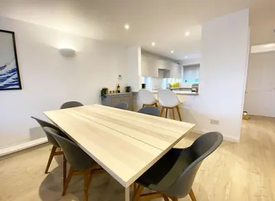 a dining room with a wooden table and chairs at 3 Harvest Moon in Newquay