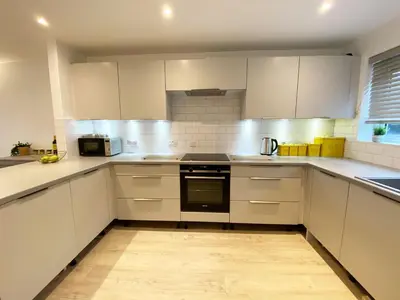a kitchen with white cabinets and a stove top oven at 3 Harvest Moon in Newquay