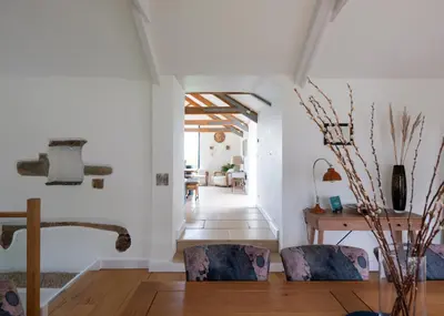 a living room with two chairs and a table at The Farmhouse - within the Helland Barton Farm collection in Delabole