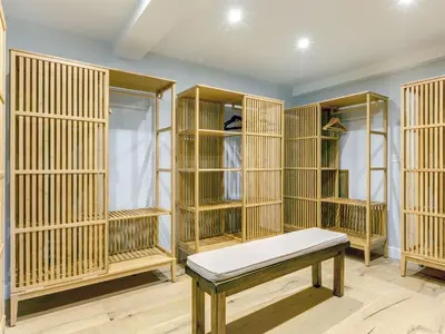 a room filled with wooden cages with a bench at The Farmhouse - within the Helland Barton Farm collection in Delabole
