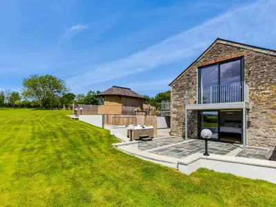 a stone house with a large yard at The Farmhouse - within the Helland Barton Farm collection in Delabole