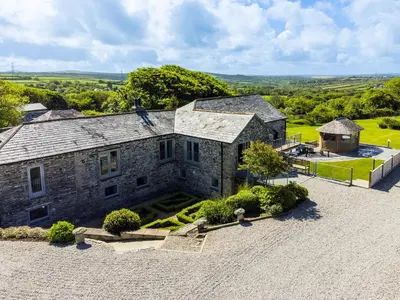 an overhead view of a stone house with a yard at The Farmhouse - within the Helland Barton Farm collection in Delabole