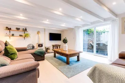a living room with a couch and a table at The Old Bakehouse - within the Helland Barton Farm collection in Delabole