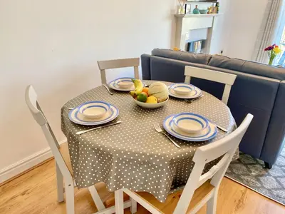 a dining room table with a bowl of fruit on it at Heidaway - Padstow in Padstow