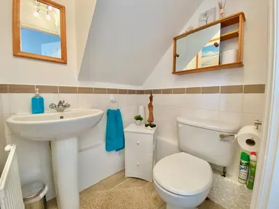 a bathroom with a sink and a toilet and a mirror at Heidaway - Padstow in Padstow