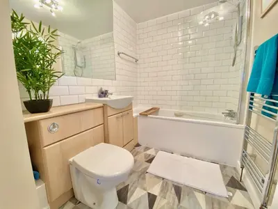 a bathroom with a toilet and a sink and a tub at Heidaway - Padstow in Padstow