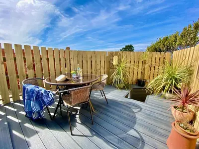 a patio with a table and chairs and a fence at Heidaway - Padstow in Padstow