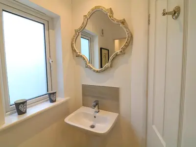 a bathroom with a sink and a mirror on the wall at Alpha in Wadebridge