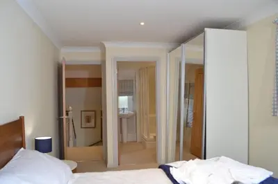 a bedroom with a bed and a walk in shower at Luxury Home on Maenporth Estate Next to the Beach in Falmouth