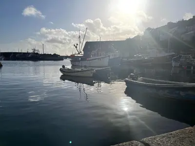 a group of boats are docked in a harbor at Inviting Traditional Fishermens cottage in the heart of the village, close to the harbour in Mevagissey