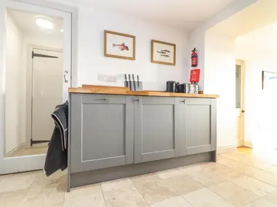 a kitchen with grey cabinets and a counter top at Ty Bryn in Marazion