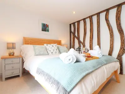 a bedroom with a bed with towels on it at Ty Bryn in Marazion