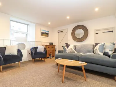 a living room with a couch and chairs and a table at Ty Bryn in Marazion