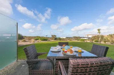 a table with food and drinks on a patio at Beach Haven in Carbis Bay