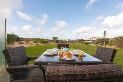 a table with a plate of food on a patio at Beach Haven in Carbis Bay