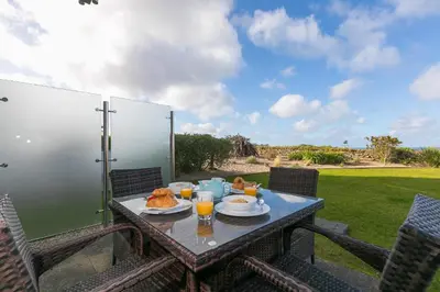 a table with food and drinks on a patio at Beach Haven in Carbis Bay