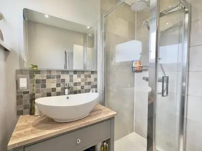 a bathroom with a sink and a shower at Curlews, 36 Egerton Road in Padstow