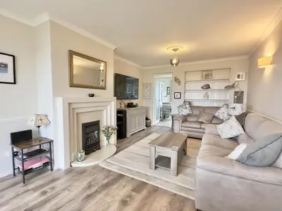 a living room with a couch and a fireplace at Curlews, 36 Egerton Road in Padstow