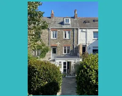 a large brick house with a driveway in front at The Cottage in Padstow