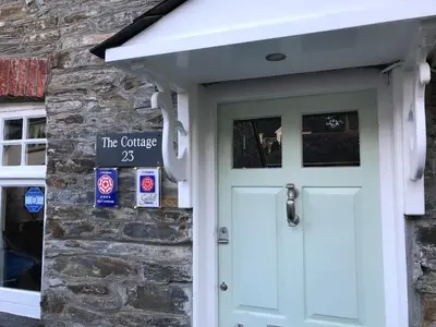 a front door of a stone house with a green door at The Cottage in Padstow