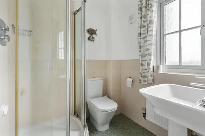 a bathroom with a toilet and a sink and a shower at Trenaton in Padstow