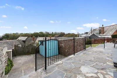 an iron fence with a gate on a patio at Trenaton in Padstow