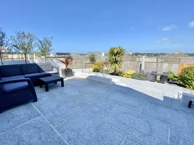 a patio with a couch and a bench on avisor at Trevillian in Padstow