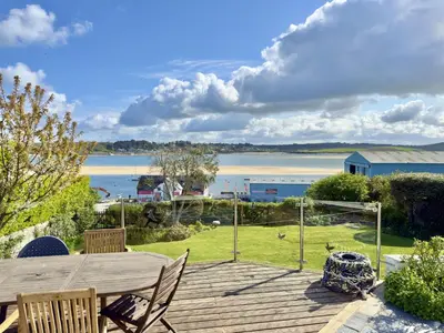 a wooden deck with a view of a body of water at Aeolian in Padstow