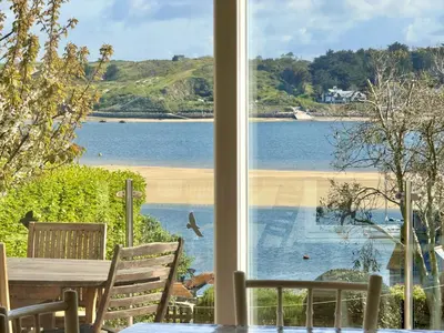 a view of a beach from a window at Aeolian in Padstow