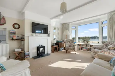 a living room with a couch and a fireplace at Aeolian in Padstow