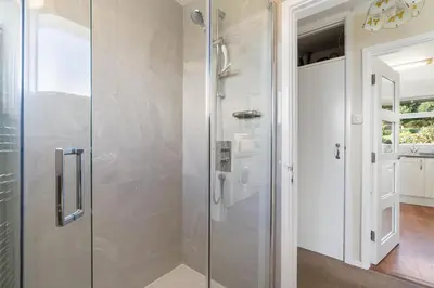 a shower with a glass door in a bathroom at Gwel Teg, 30 Egerton Road in Padstow