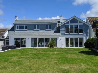 a blue house with a lawn in front of it at Boskilly in St Merryn