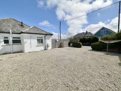 a house with a gravel driveway in front of it at Hardown in St Merryn