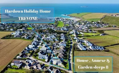 an aerial view of a town with houses and the ocean at Hardown in St Merryn