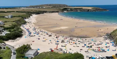 a beach with a large crowd of people at Morwennol in St Merryn