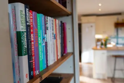 a row of books on a book shelf at Polcarrek in St Merryn