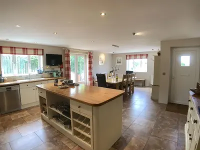 a kitchen with a island with a wooden counter top at Polcarrek in St Merryn