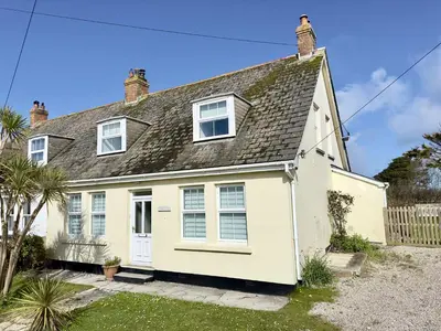 a white house with a grey roof at Treaaron in St Merryn
