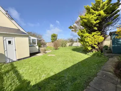 a yard of a house with a green lawn at Treaaron in St Merryn