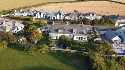 an aerial view of a large estate with houses at Treaaron in St Merryn