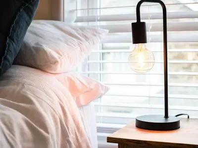 a black lamp on a table next to a bed at The Lookout in Wadebridge