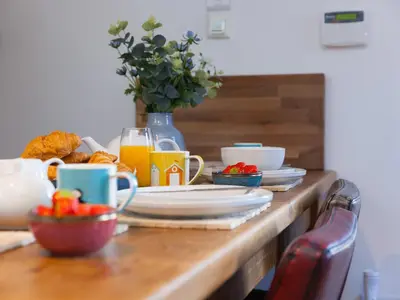 a table with plates of food and drinks on it at St Ives View in St Ives