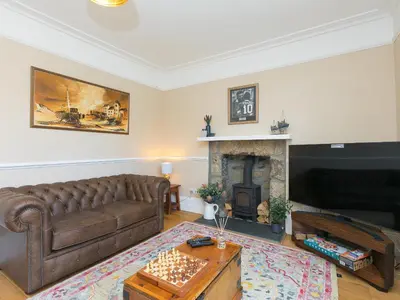 a living room with a couch and a fireplace at St Ives View in St Ives