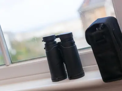 two black bottles sitting on a window sill at St Ives View in St Ives